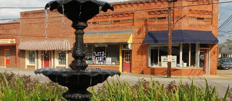 Fountain and storefronts in downtown Lanett, Alabama